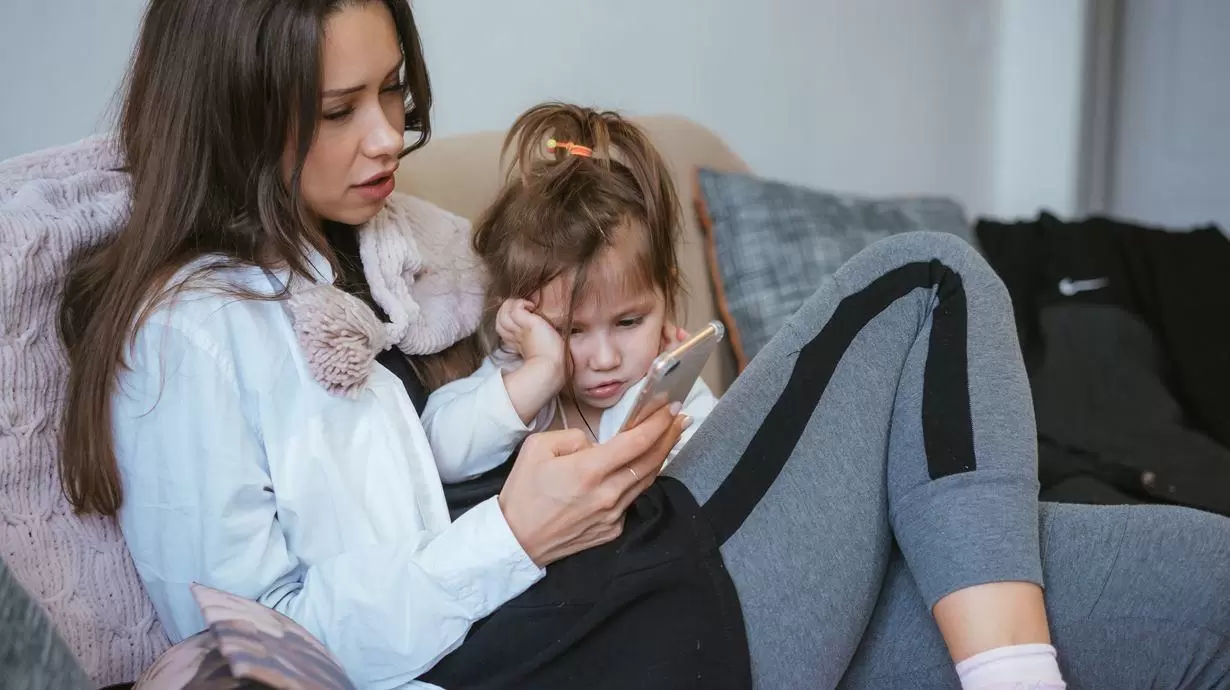 Parent Looking At Phone With Kid Watching | Screen Time