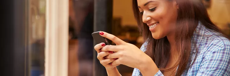 Woman using her phone to access public wifi